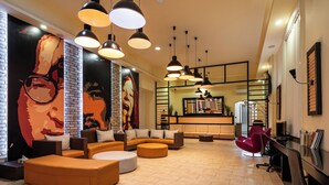 A modern interior with a large mural, multiple seating areas, and pendant lighting. - Full Moon Budapest (Budapest)