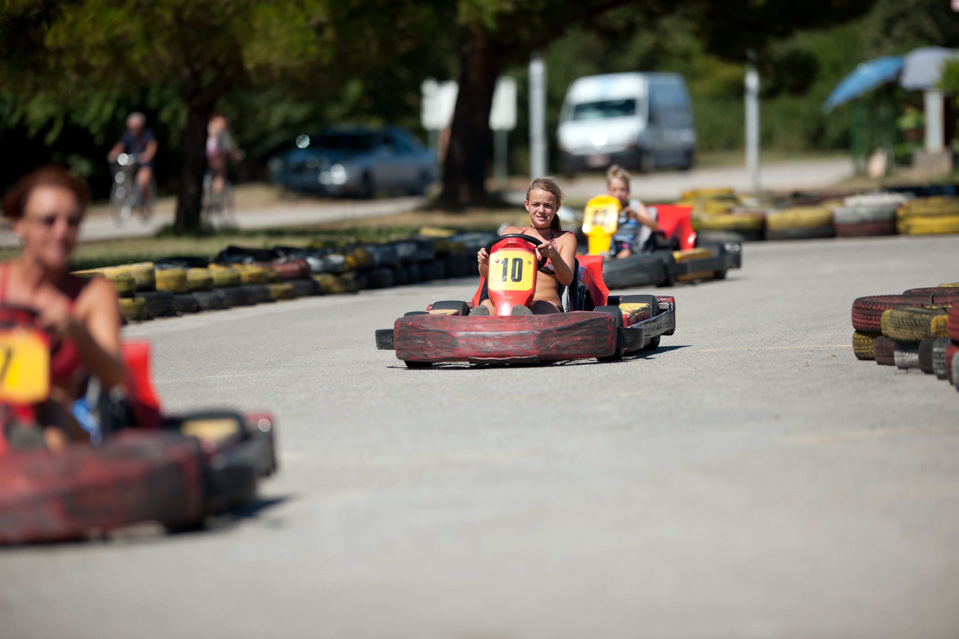 A go-kart track with participants in go-karts.