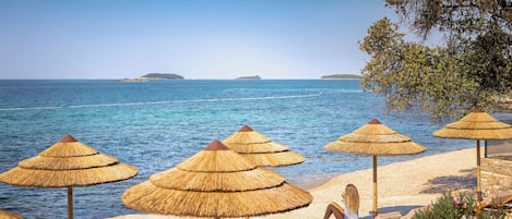 On the beach, sun-loungers, beach umbrellas, surfing