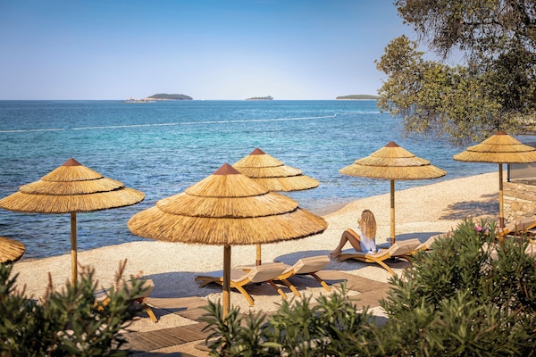 On the beach, sun loungers, beach umbrellas, surfing