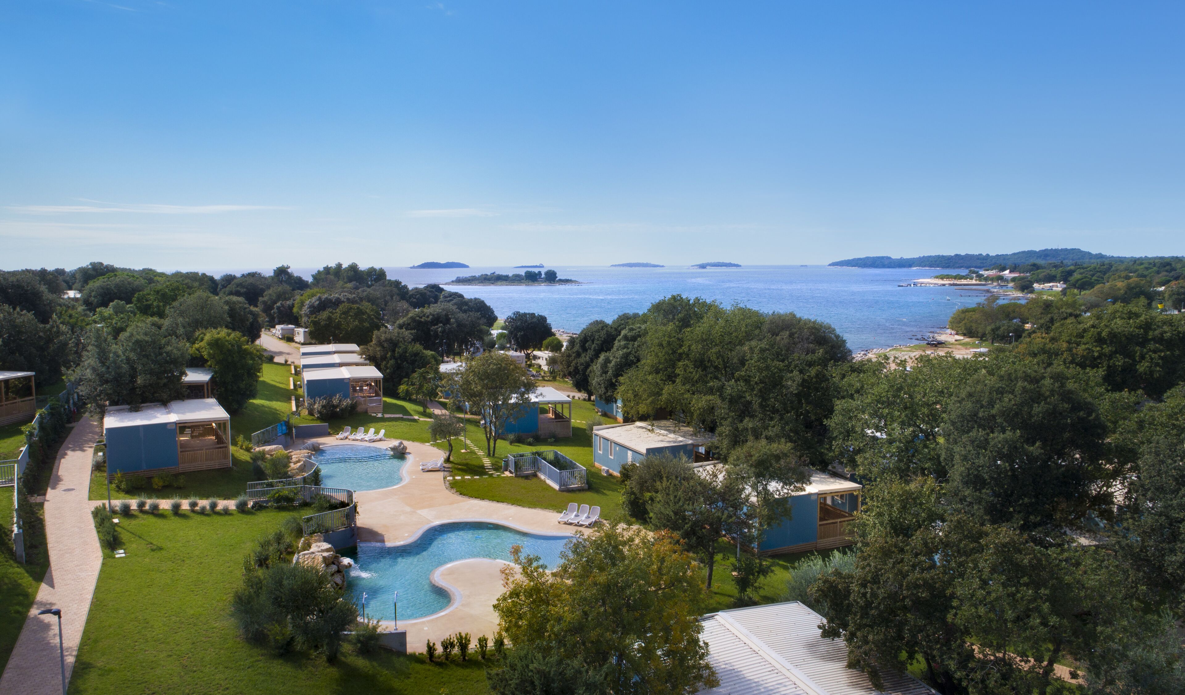 A resort with a swimming pool, beach, and ocean views.