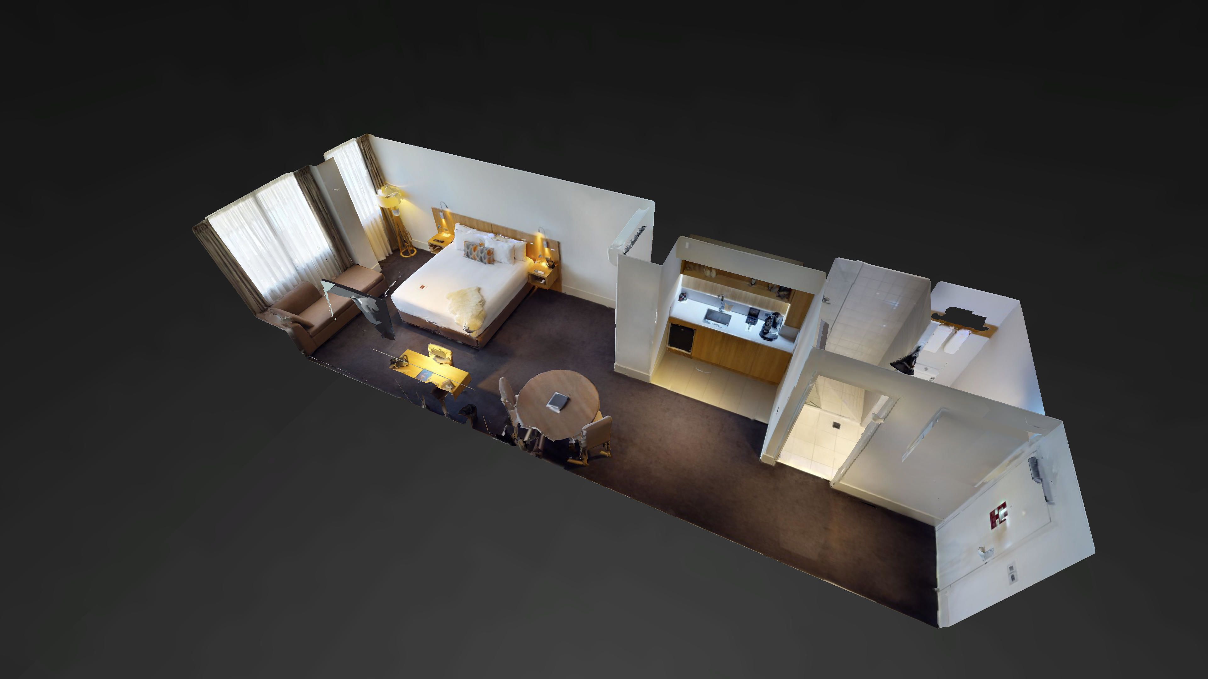 A 3D layout of a hotel room with a bed, a sofa, a dining table, and a kitchenette.