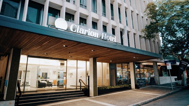 A hotel entrance with a modern facade, a visible reception area, and a staircase leading to the entrance. - Clarion Hotel Townsville (Townsville)