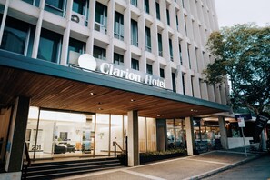 A hotel entrance with a modern facade, a visible reception area, and a staircase leading to the entrance. - Clarion Hotel Townsville (Townsville)