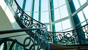 A glass-domed atrium with a spiral staircase and decorative metal railings. - Crowne Plaza Bandung by IHG (Bandung)