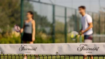 Una cancha de tenis con una red que dice 'Fairmont AJMAN'.