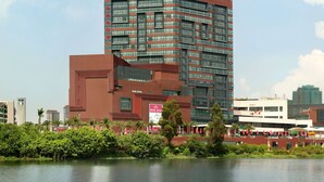 A modern building with the name 'RAMADA' prominently displayed at the top. - Ramada Foshan Nanhai (Foshan)