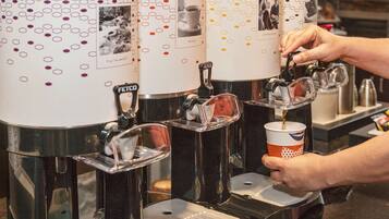 A coffee machine with multiple dispensers, each labeled with different types of coffee.