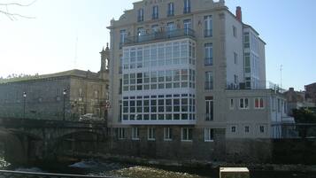A multi-story building with a prominent entrance and a balcony.