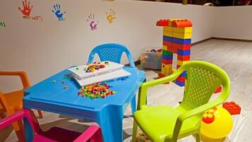 Children can play and build at the table with a variety of toys and blocks.