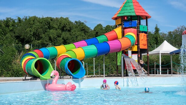 A water park with a colorful spiral slide, a small tower, and a pool area. - Campingvillaggio Atlanta e Mediterraneo - Campground (Chioggia)