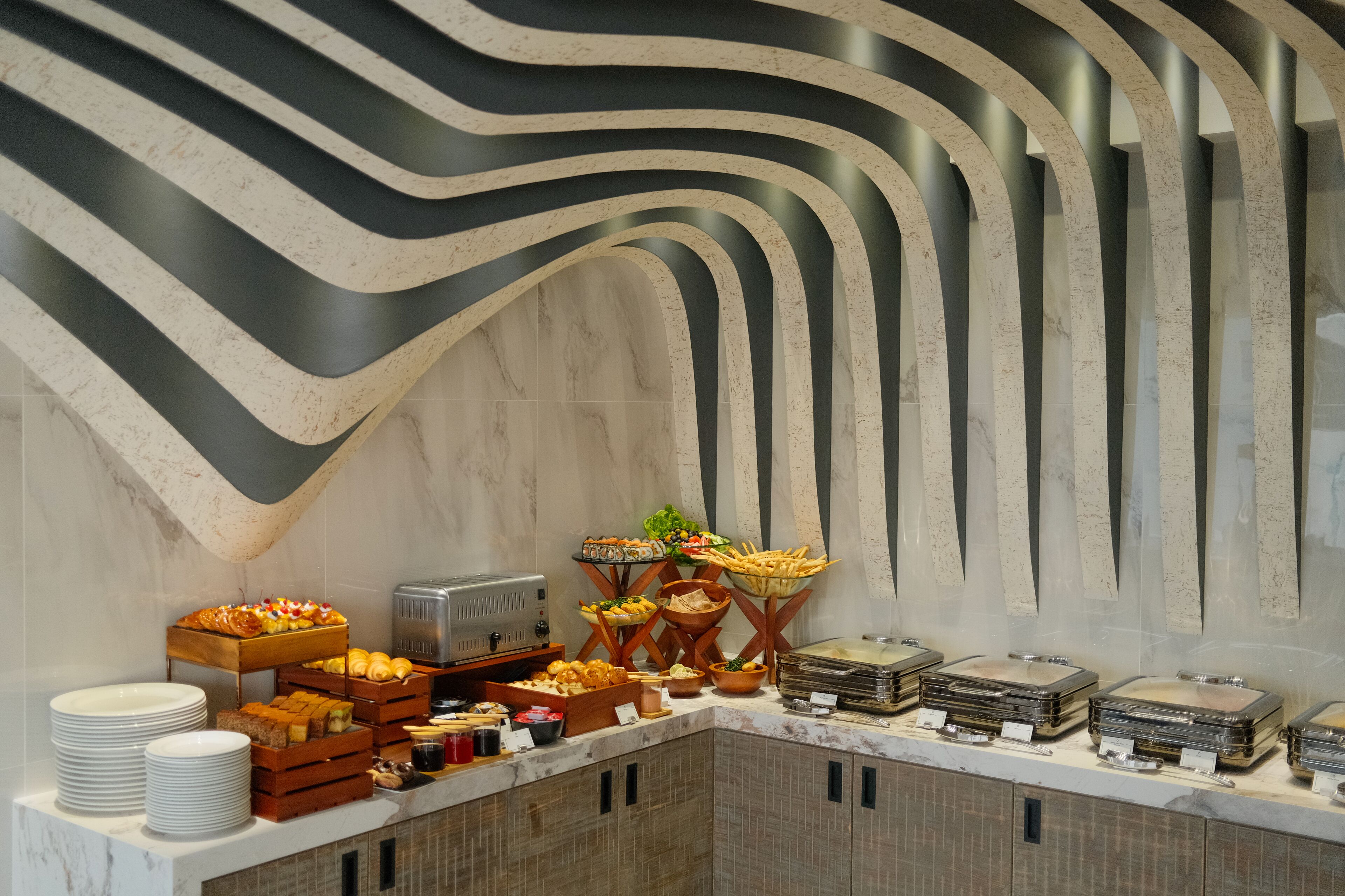 A buffet setup with various food items and a self-service beverage station.