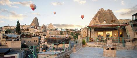 A historic town with stone buildings and a prominent rock formation.
