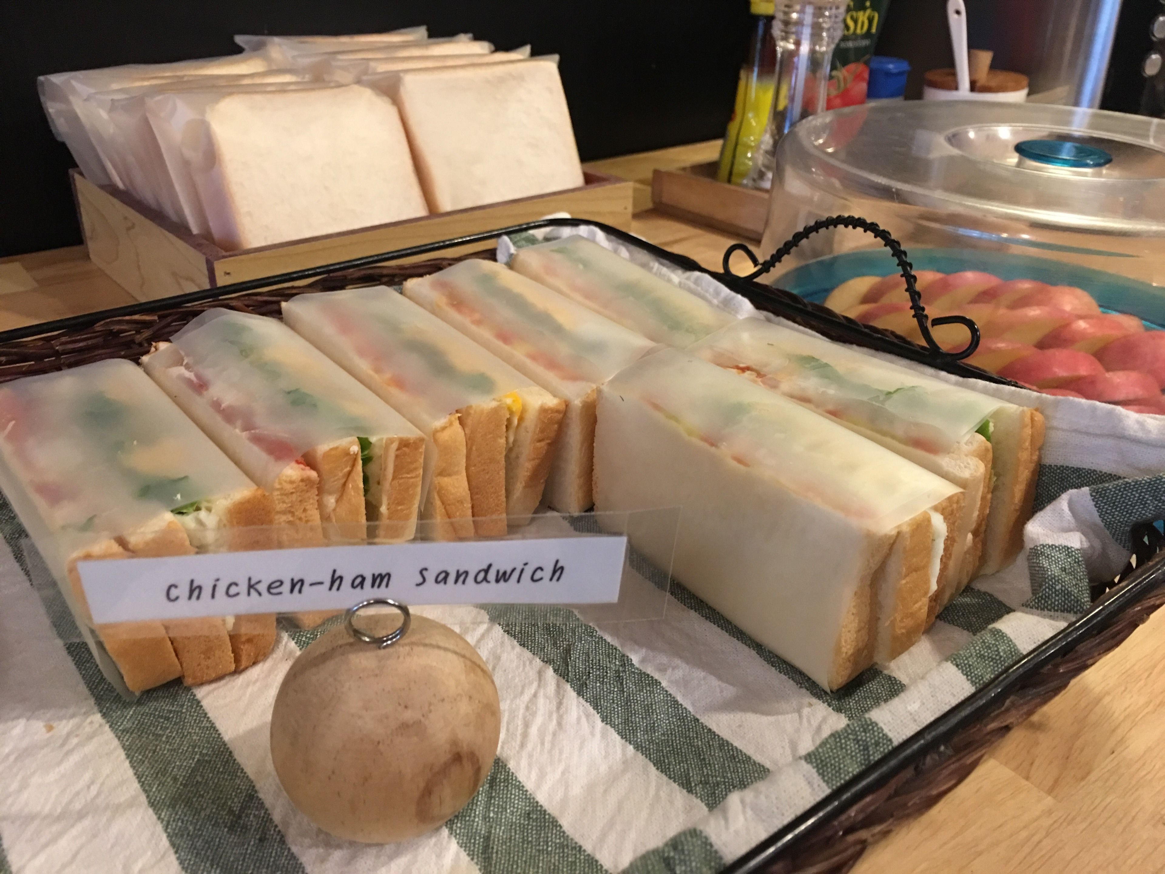 A tray of chicken-ham sandwiches with a label.
