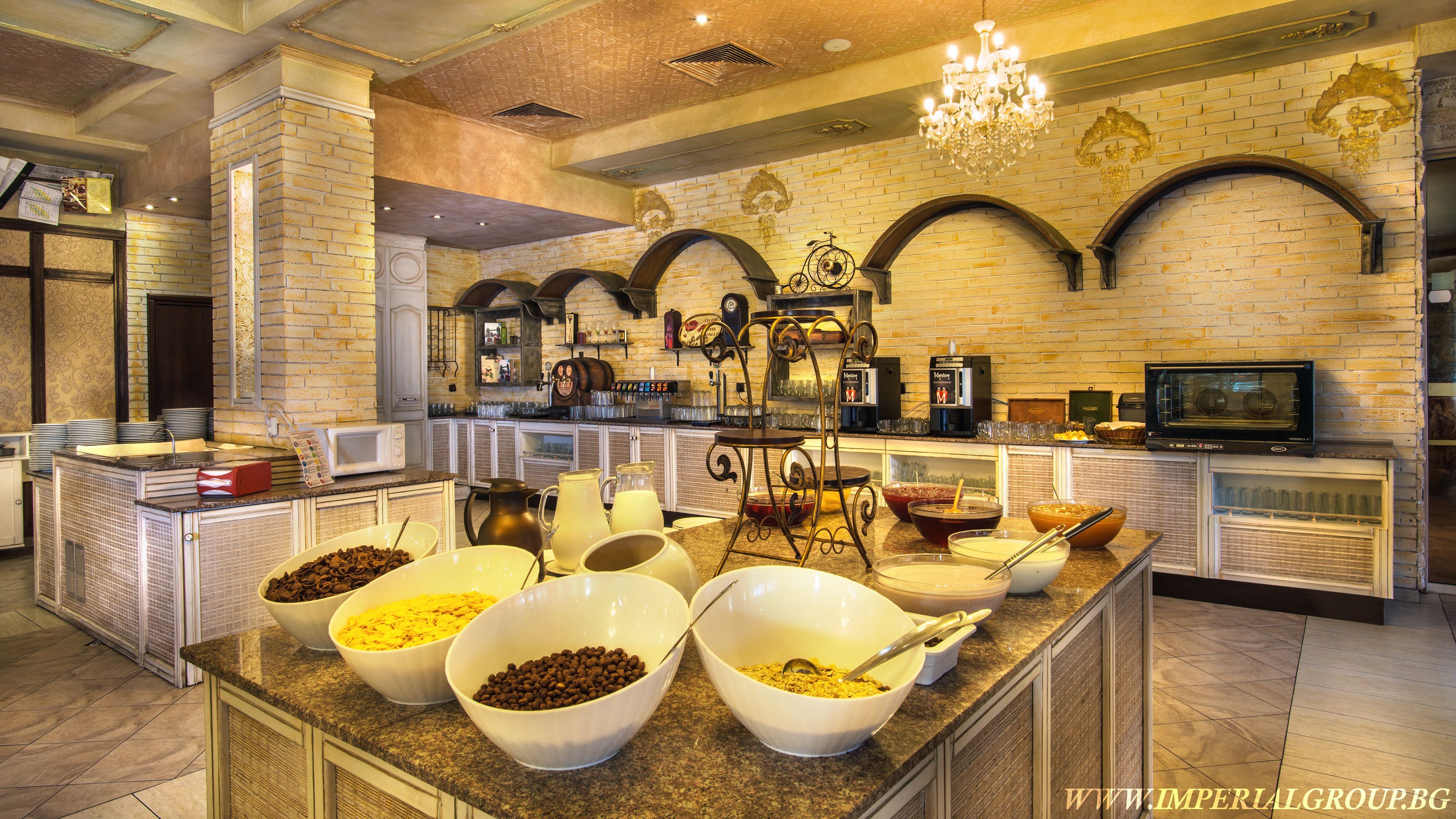 A buffet setup with various food items and a coffee station.