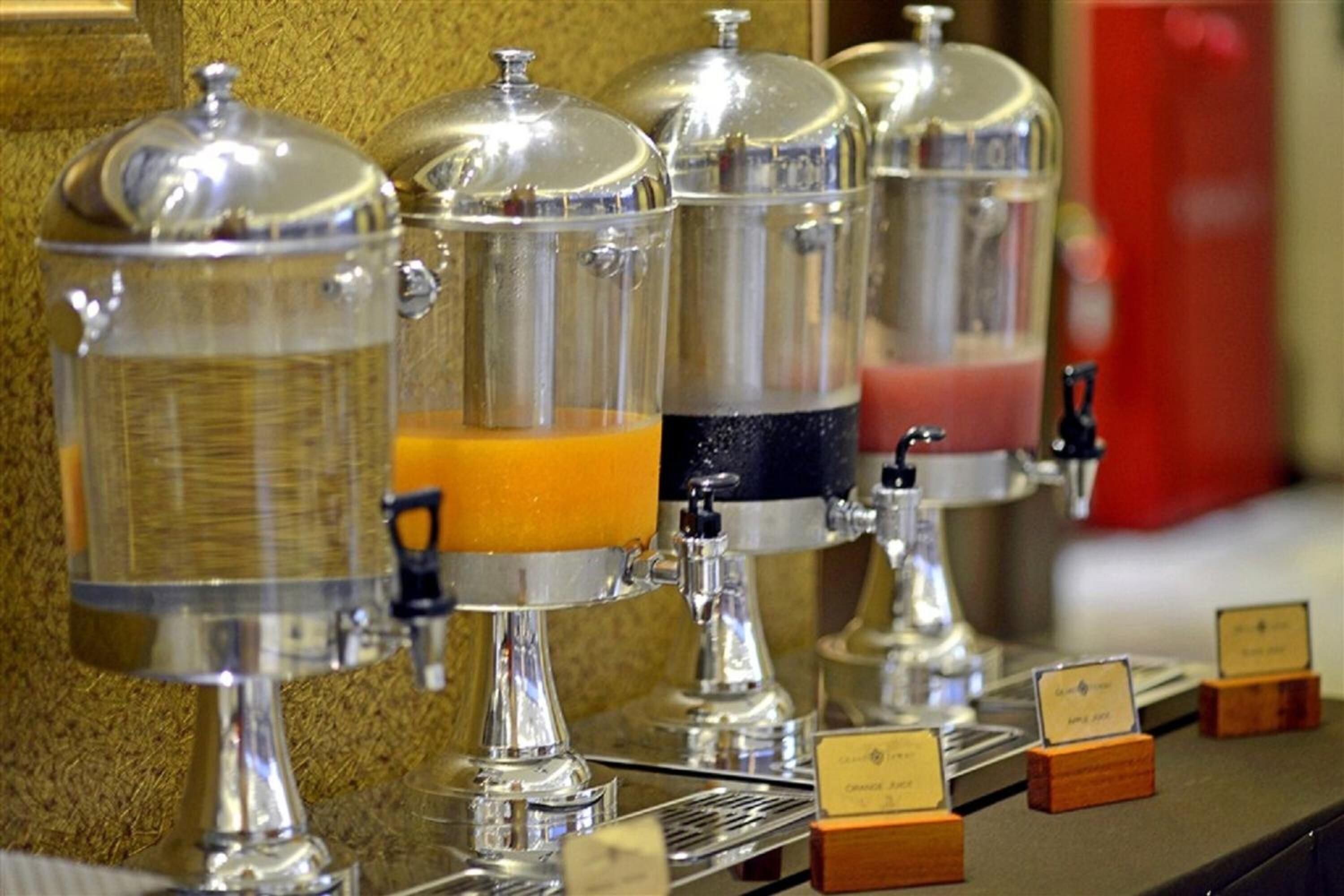 A coffee station with multiple dispensers, each with a different beverage option.