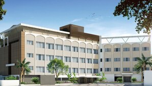 A modern hotel with multiple floors, large windows, and a central courtyard with palm trees. - Best Western Ashoka (Hyderabad)