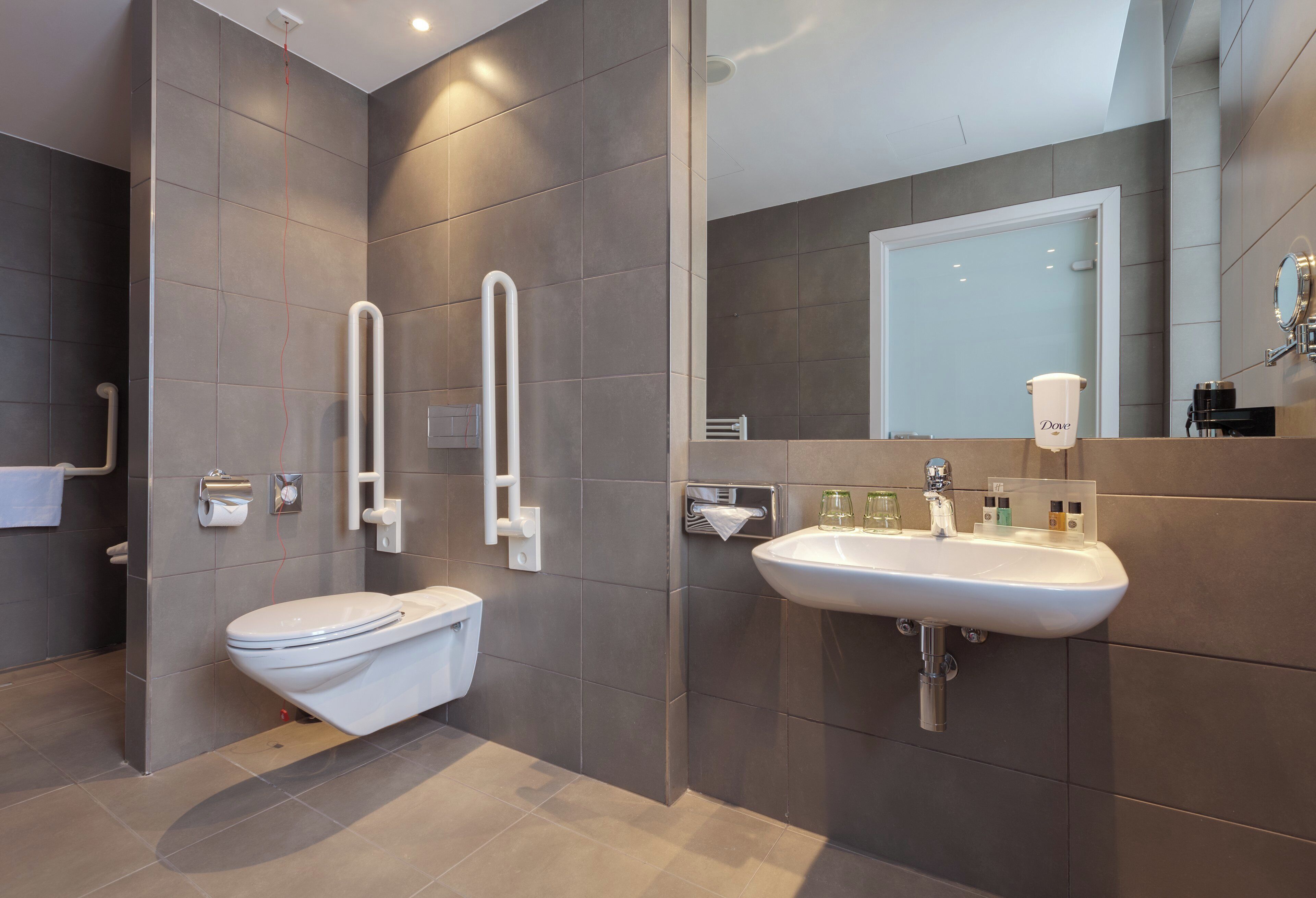 A modern bathroom with a toilet, bidet, and sink.