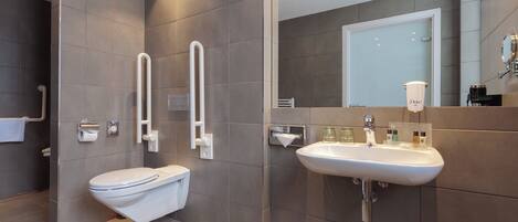 A modern bathroom with a toilet, bidet, and sink.