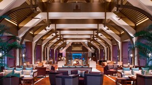 A spacious lobby with high ceilings, modern seating arrangements, and a central area with a view of the outdoors. - Sheraton Grand Xishuangbanna Hotel (Xishuangbanna Dai)