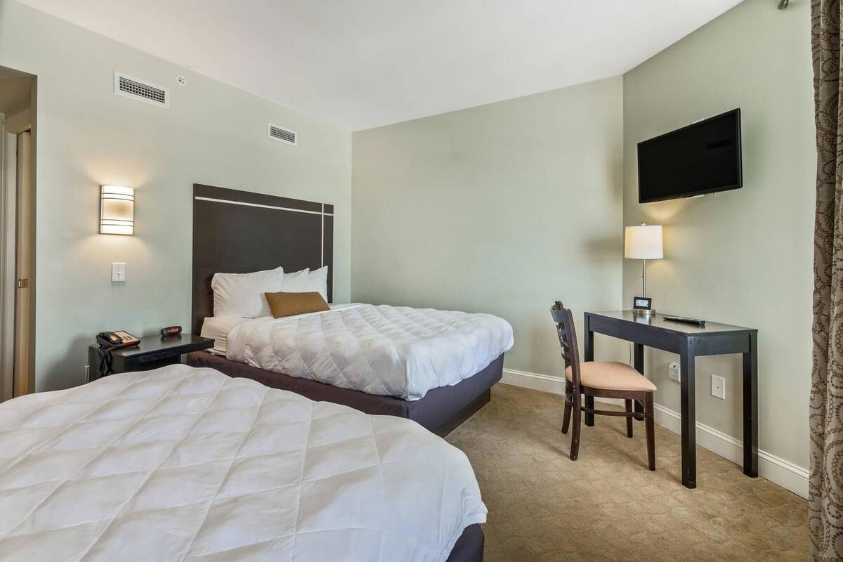 Premium bedding, desk, laptop workspace, blackout drapes