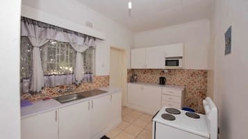 Full-size fridge, microwave, stovetop, electric kettle