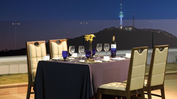 A table set for dining with a view of a tower in the background. - Migliore Hotel Seoul Myeongdong (Seoul)
