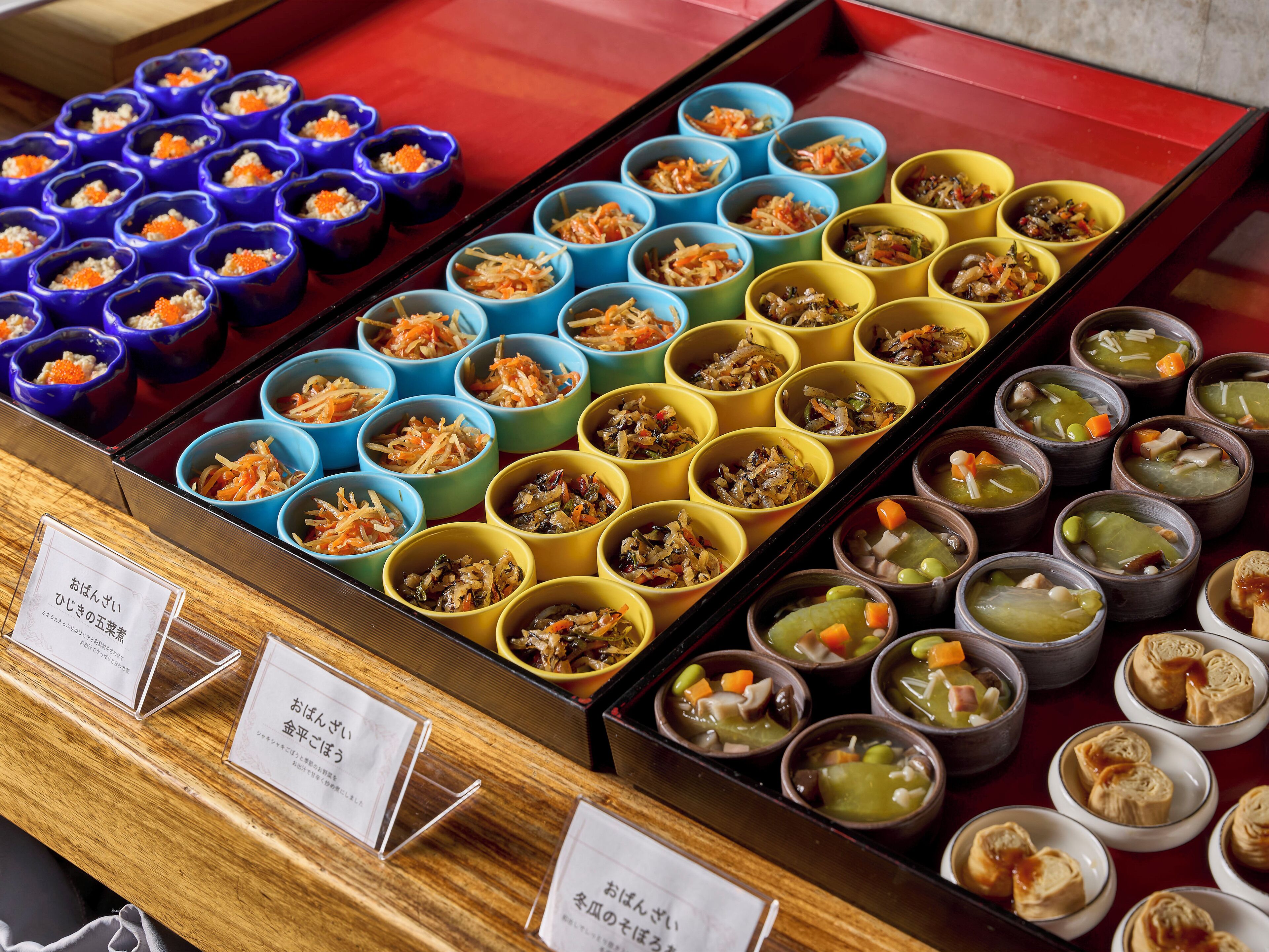 Diversos alimentos dispuestos en coloridos cuencos sobre una mesa de madera.