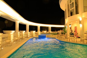 Outdoor pool, a rooftop pool, pool umbrellas, sun loungers