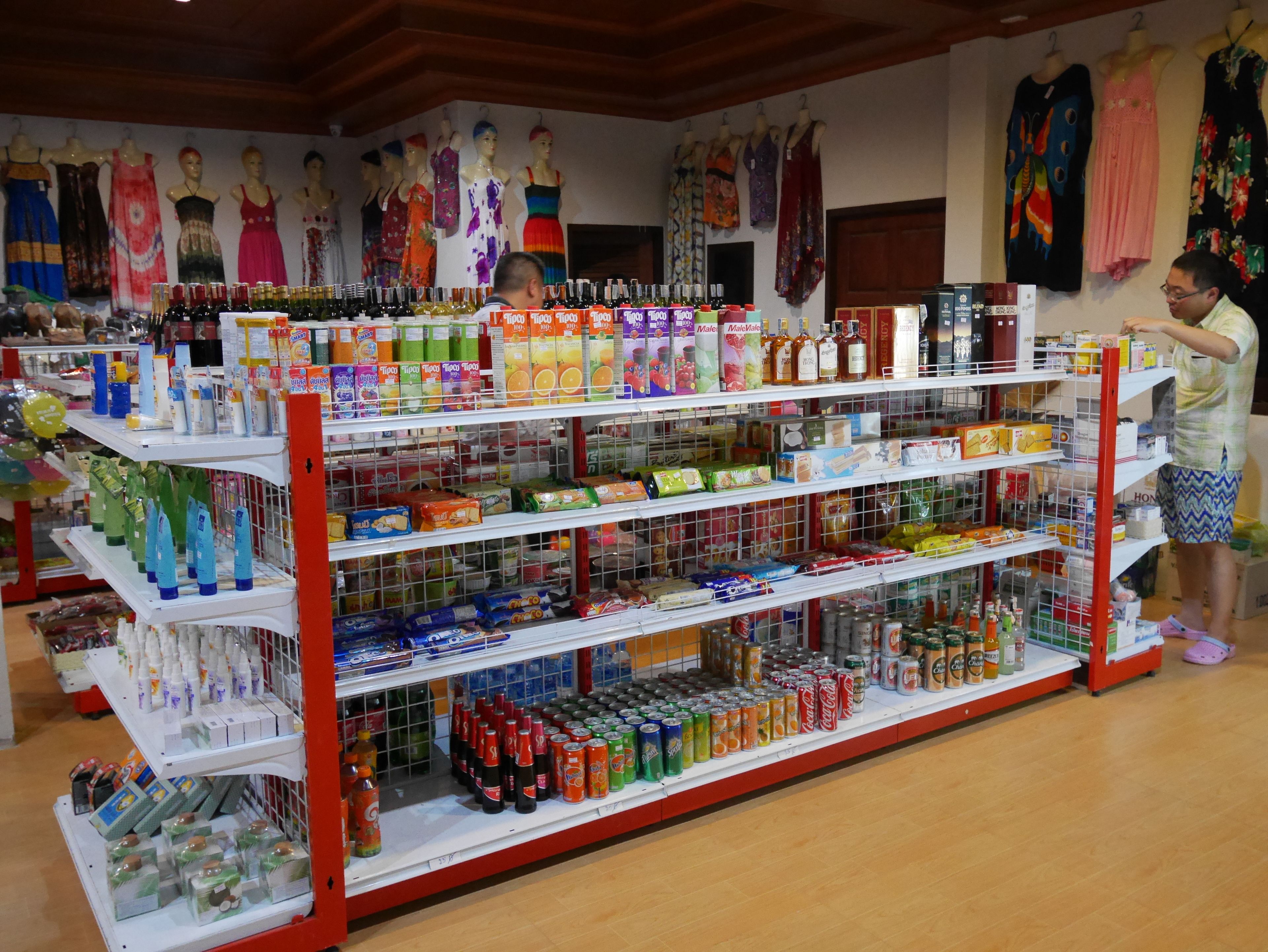 A store with shelves stocked with various beverages and snacks.
