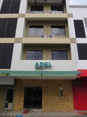 A hotel with a sign reading "ADEL HOTEL" above the entrance. - Adel Hotel (Kota Kinabalu)