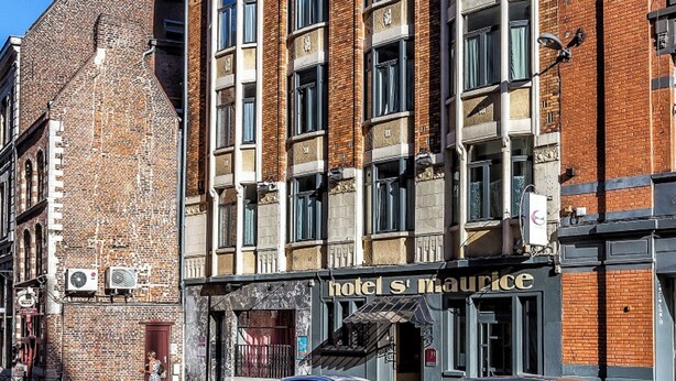 A multi-story hotel with a brick facade and large windows. - Hotel Saint Maurice (Lille)