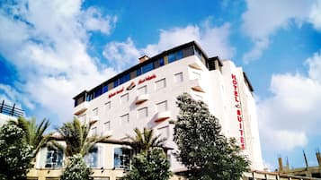 Hotel Sultans offers a striking modern design with a prominent sign and flat roof.