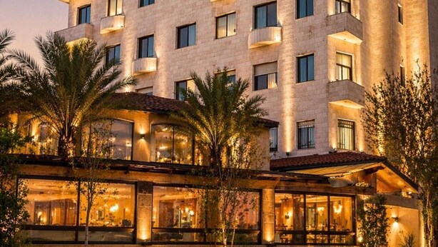 A multi-story hotel with a modern design, featuring balconies and large windows. - Panorama Amman Hotel (Amman)