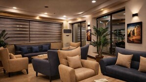 A modern living room with sofas, armchairs, and a coffee table. - Panorama Amman Hotel (Amman)