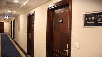 A hotel hallway with doors numbered 609, 610, 621, and 627.