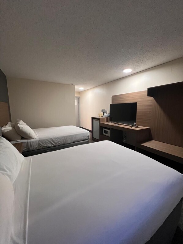 Hypo-allergenic bedding, desk, laptop workspace, blackout drapes