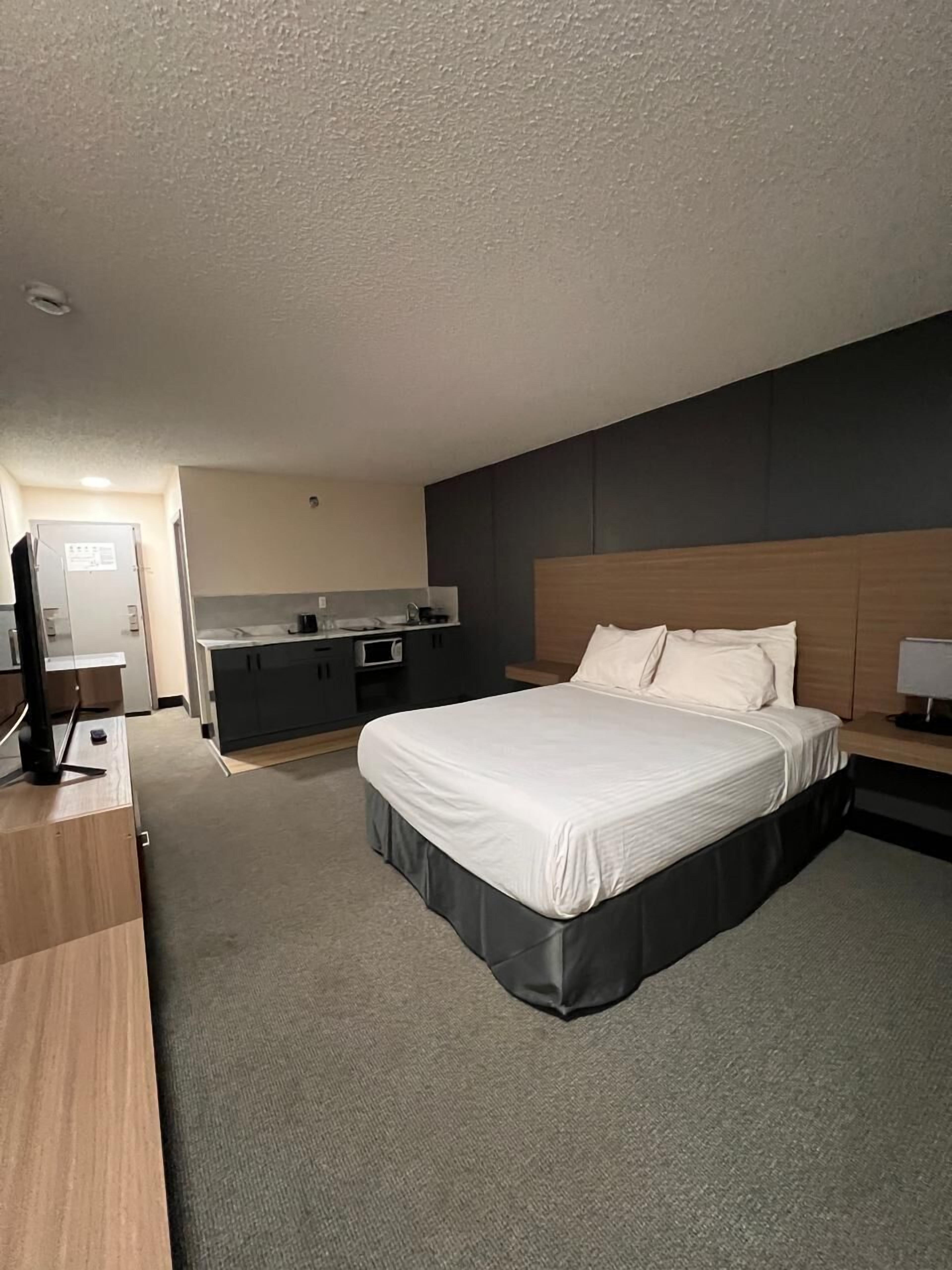 Hypo-allergenic bedding, desk, laptop workspace, blackout drapes