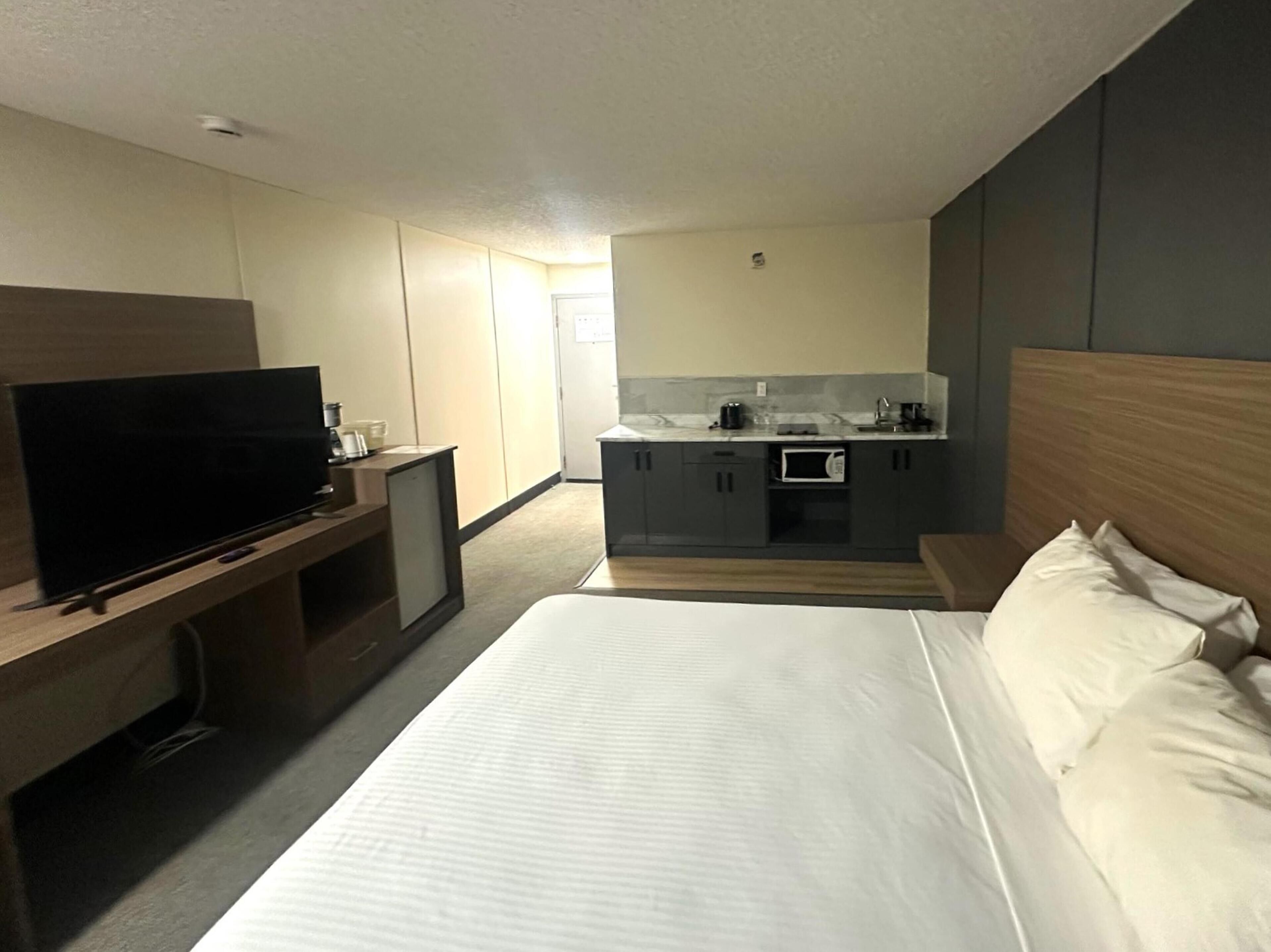 Hypo-allergenic bedding, desk, laptop workspace, blackout drapes