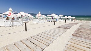 A wooden boardwalk leading to beach umbrellas and lounge chairs. - Amfora Hotel (SUNNY BEACH)