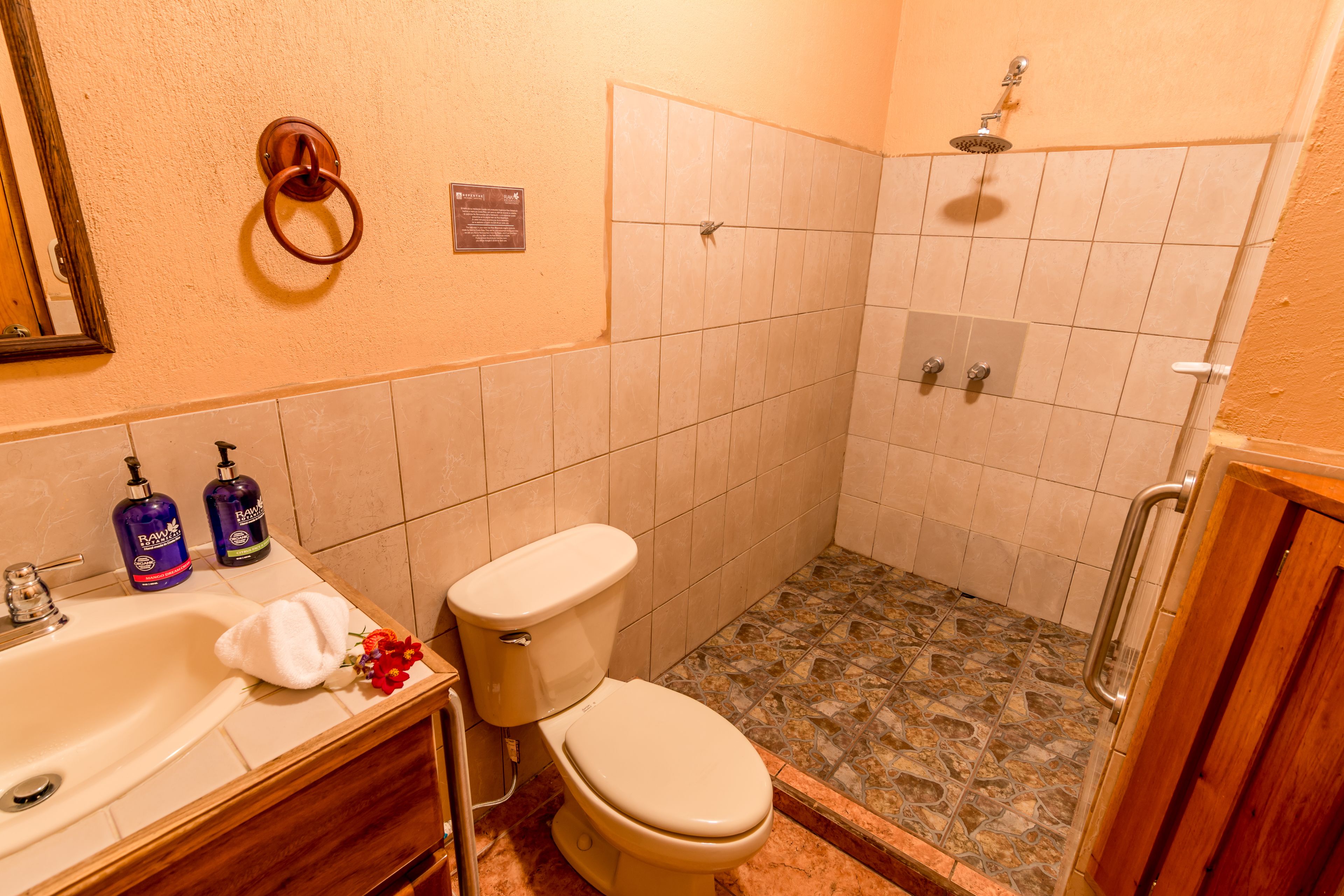 A bathroom with a toilet, sink, and shower.