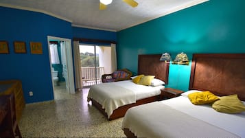 A hotel room with two beds, a balcony, and a view of the outdoors.