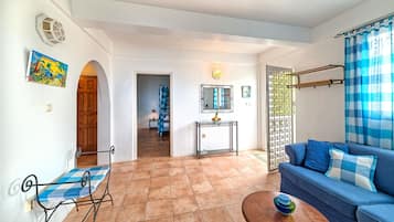 The Sunset, 1 Bedroom Apartment | Living room | 43-inch Smart TV with cable channels, TV, streaming services