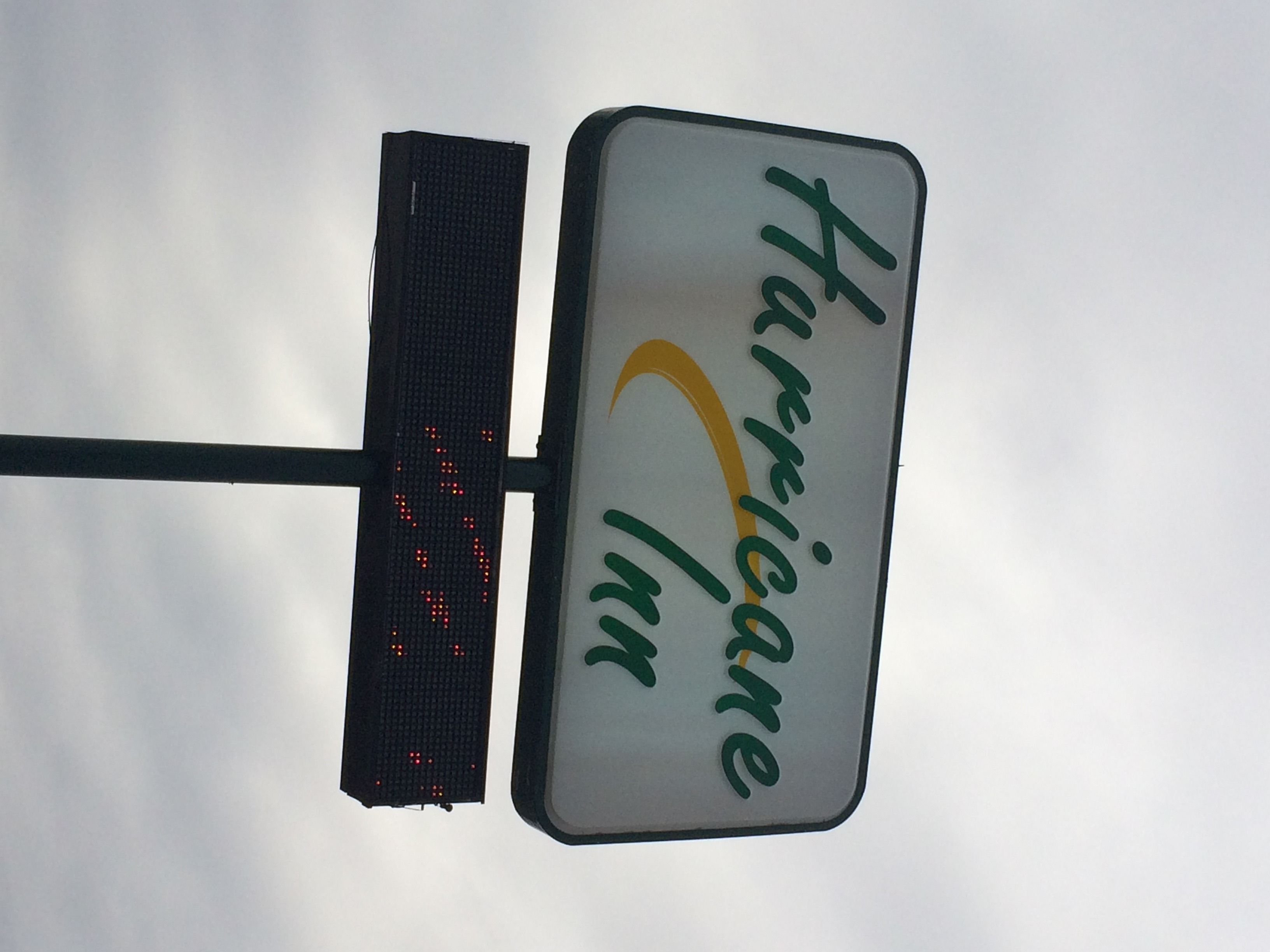 A sign with the text "Hurricane Inn" and a digital display.