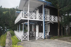 A two-story building with a balcony and a covered porch area. - Kinabalu Pine Resorts (Ranau)