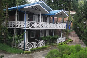 A two-story building with a balcony, surrounded by greenery. - Kinabalu Pine Resorts (Ranau)