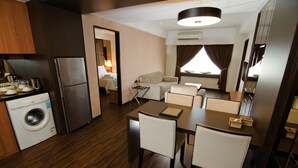 A compact hotel room with a kitchenette, a dining area, a living space, and a bathroom. - C'haya Hotel (Kota Kinabalu)