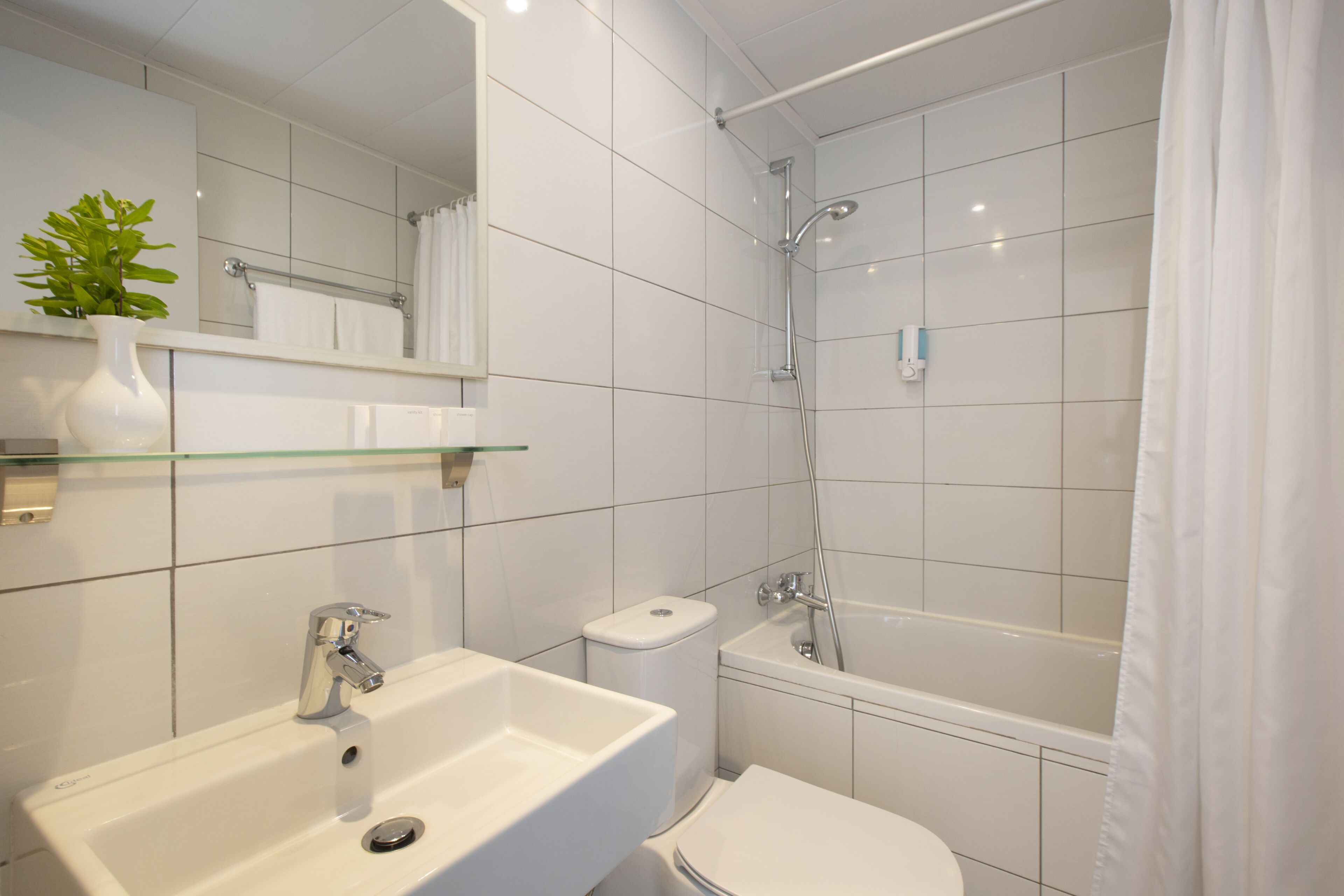 shower, hair dryer, slippers, towels