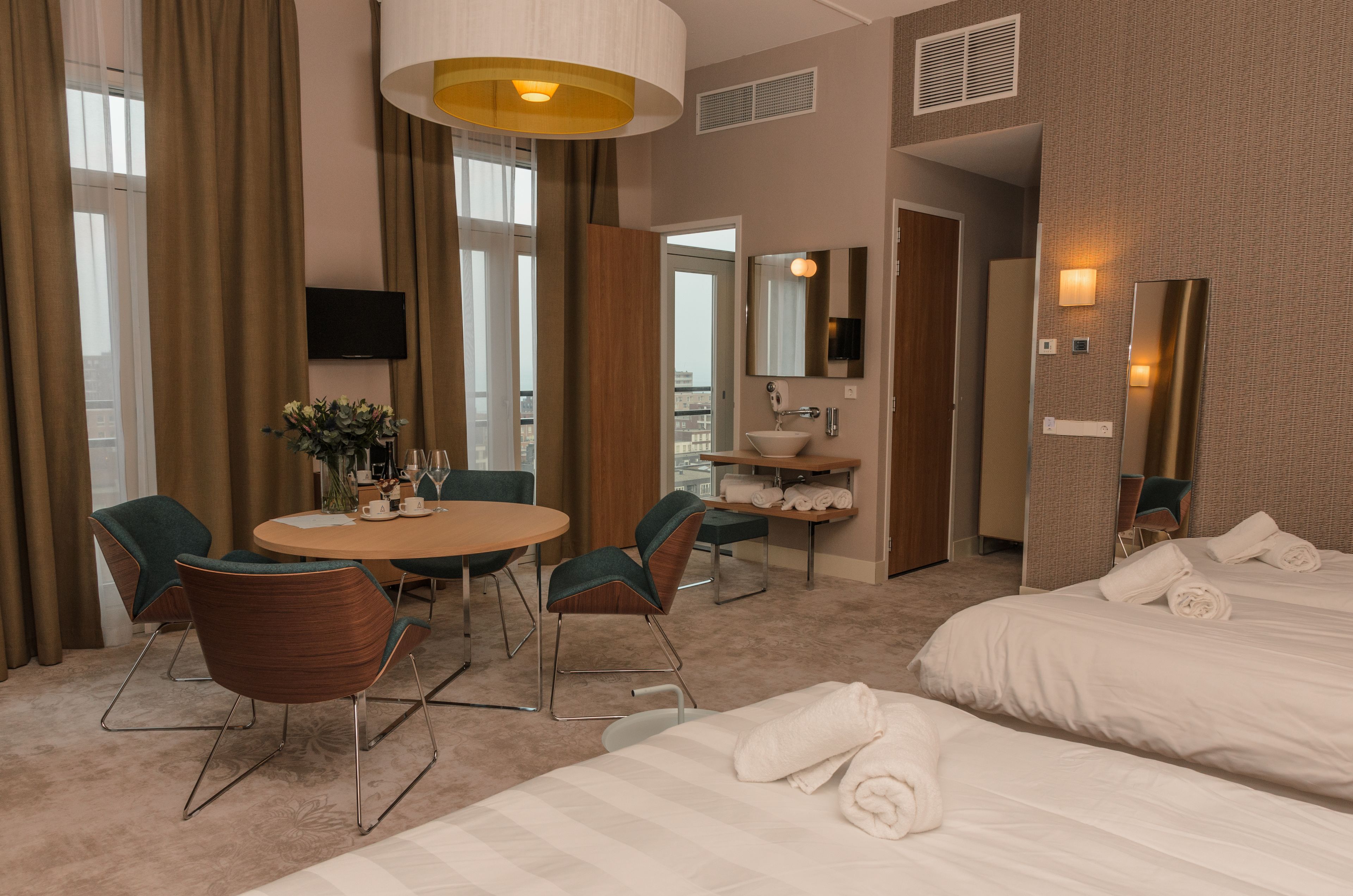 deluxe quadruple room | living area | 32-inch flat-screen tv with cable channels, tv