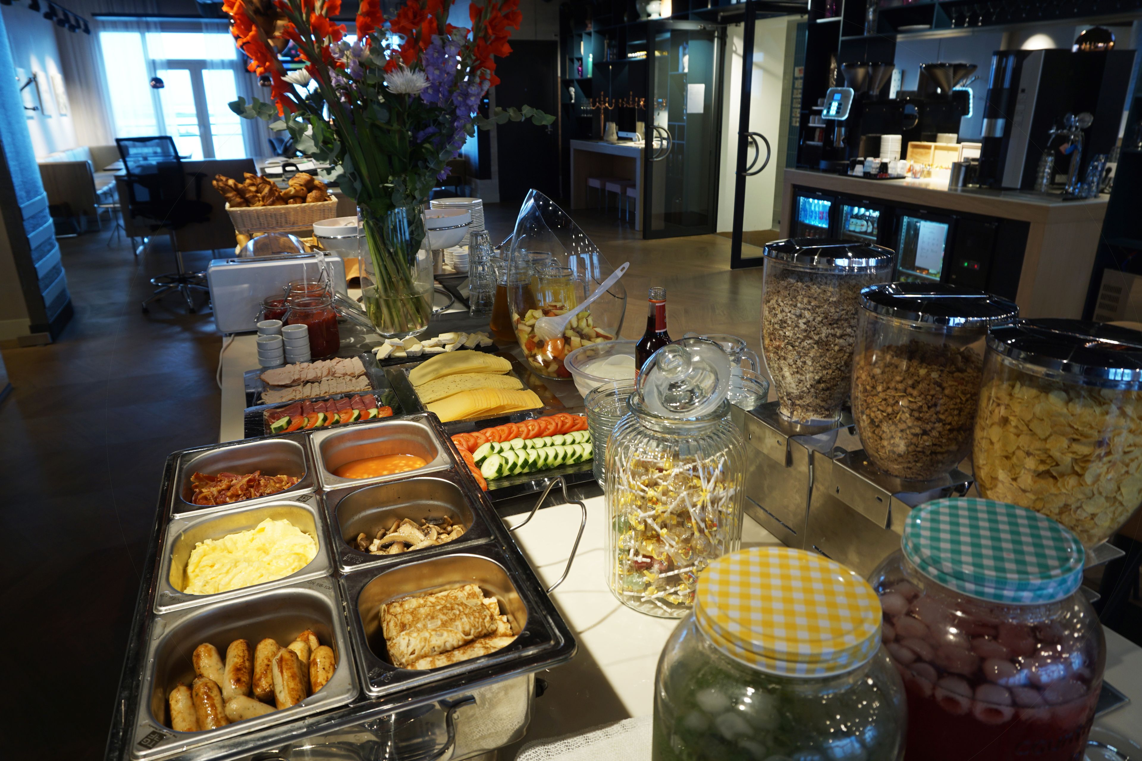 A buffet with various food items and condiments.